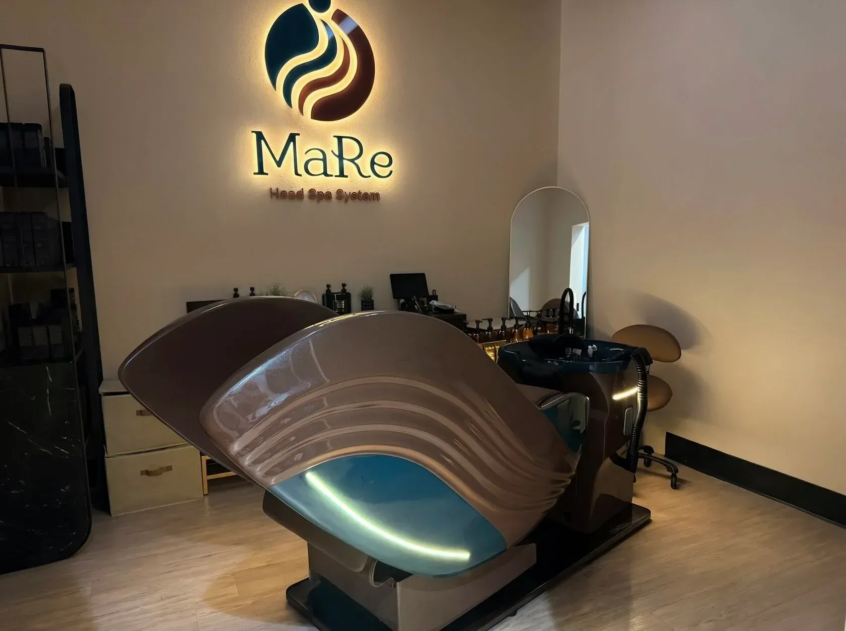 The MaRe Capsule under the illuminated MaRe logo in the Coral Gables head spa